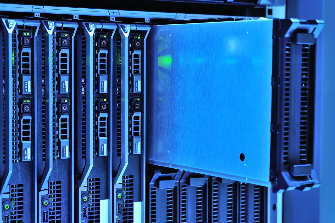 Rows of servers lit in blue inside a data centre